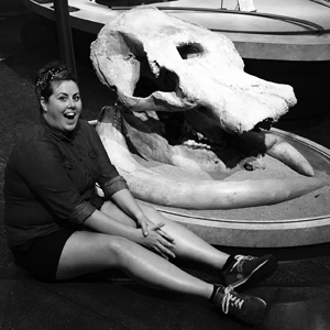 Photo of Christina Olson next to Max the Mastodon skull